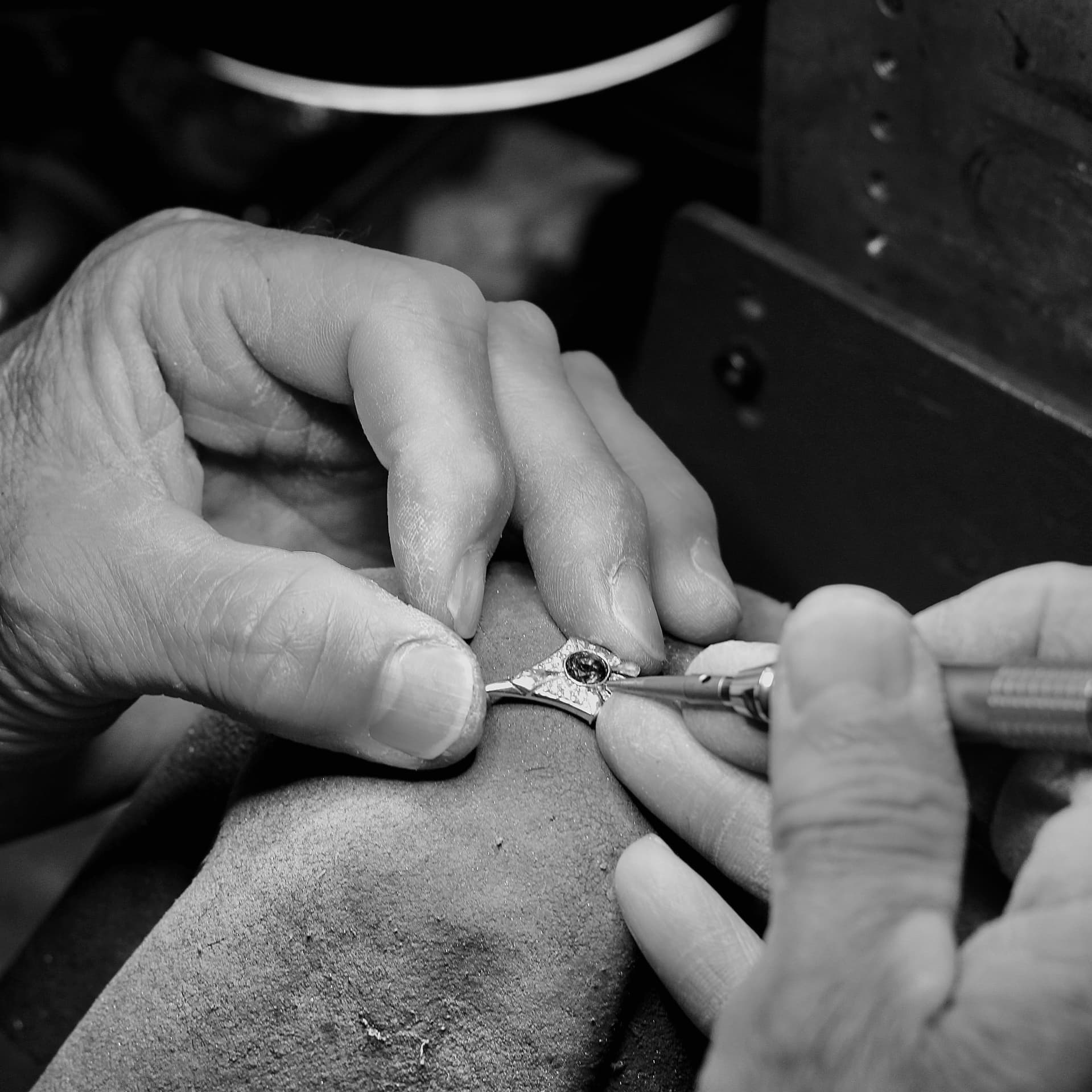 A Kabana jeweler at the bench, setting a stone by hand